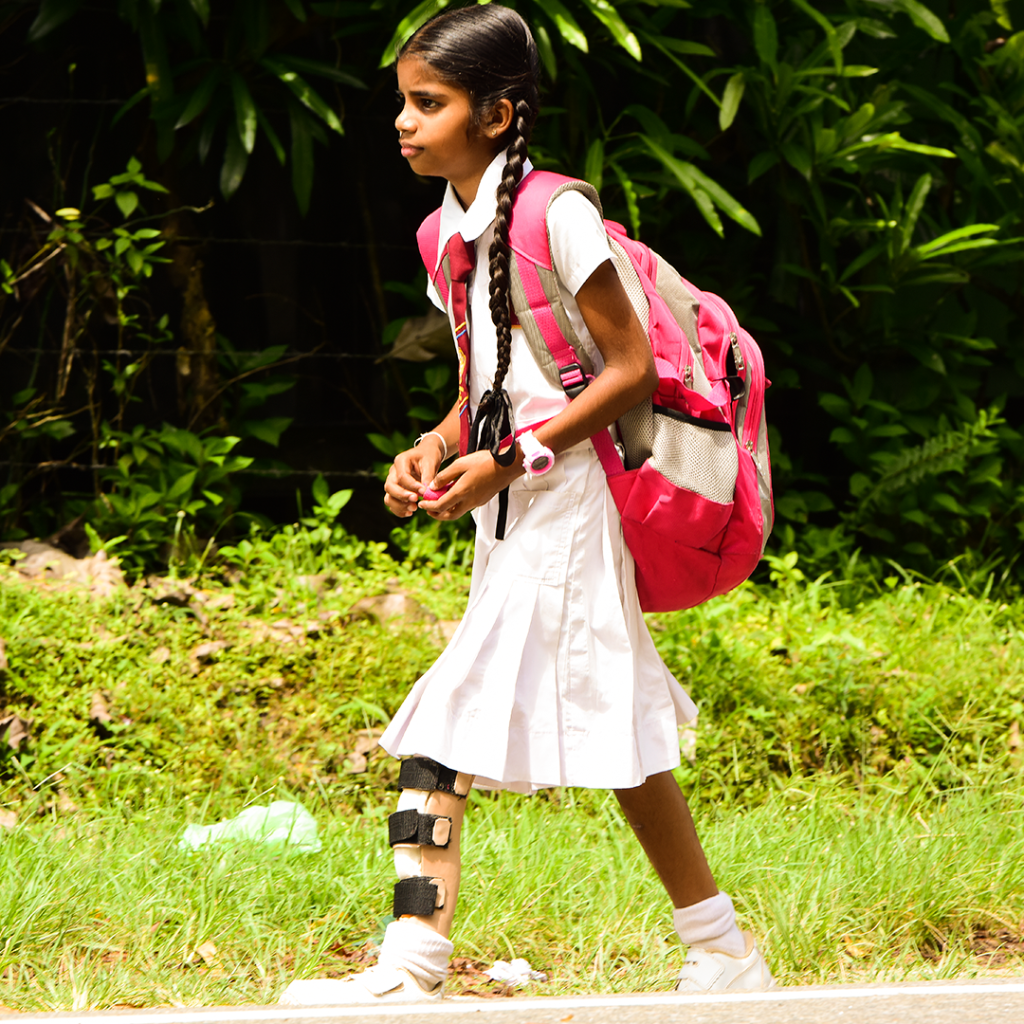 A schoolgirl walking with her new limb made by CFH Sri Lanka